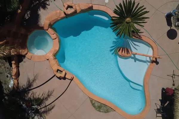 Aerial view of the completed pool filled with clear turquoise water